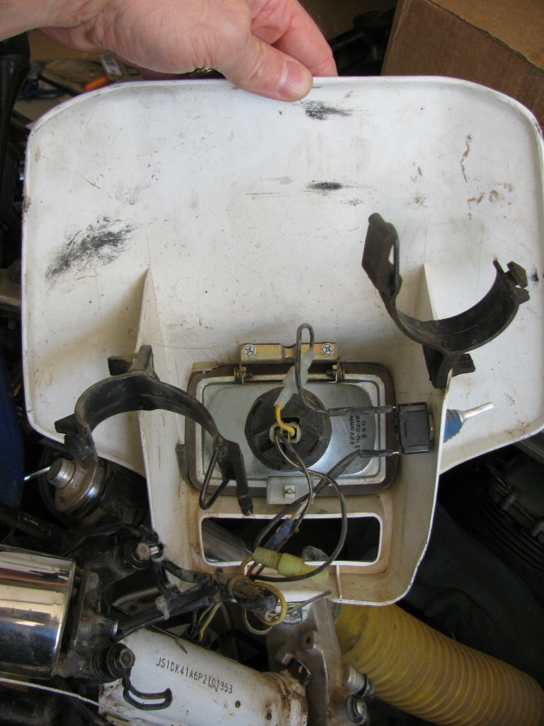 Headlight and shroud from a 1993 Suzuki DR350 dirt model.