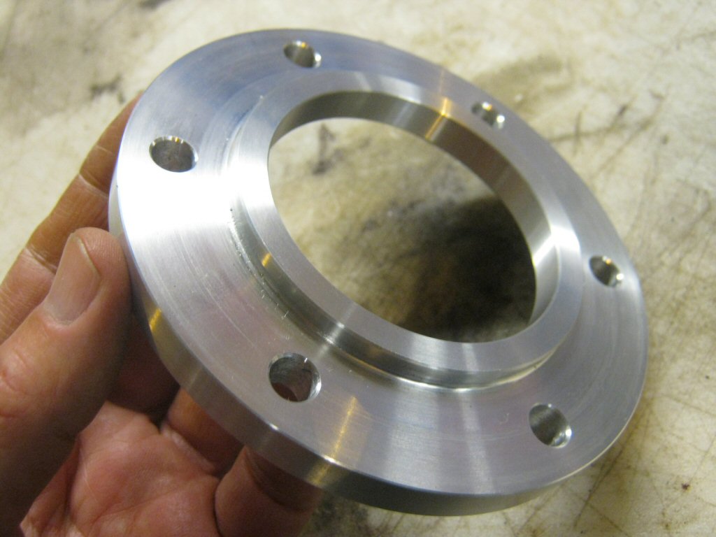 Disc brake spacer as used to fit a disc brake to drum brake Moto Guzzi V700, V7 Special, Ambassador, 850 GT, 850 GT California, Eldorado, and 850 California Police motorcycles.Spacer made by Steve Odell.