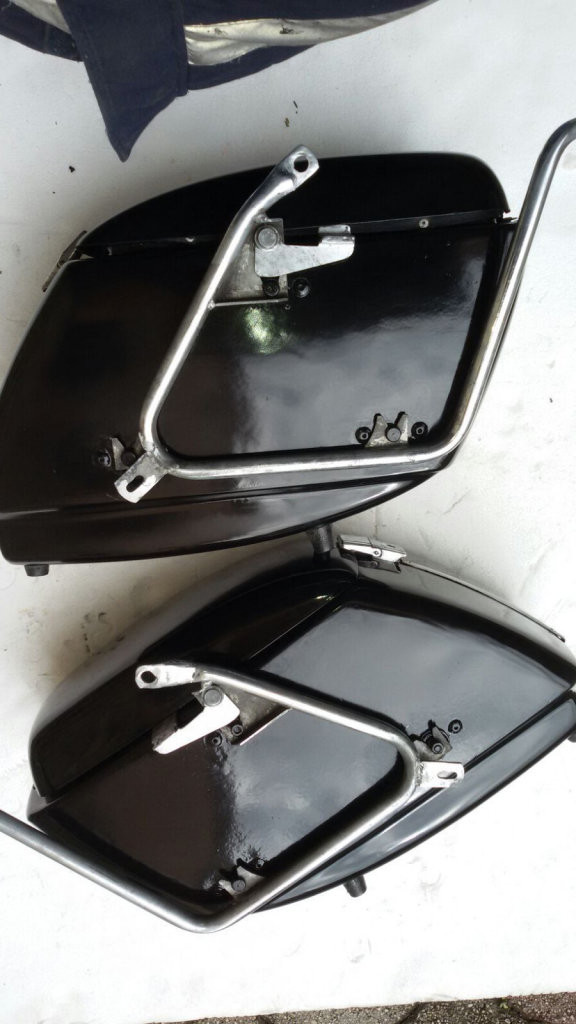 Original Moto Guzzi saddlebags that have had the handles removed from the lid (smaller).