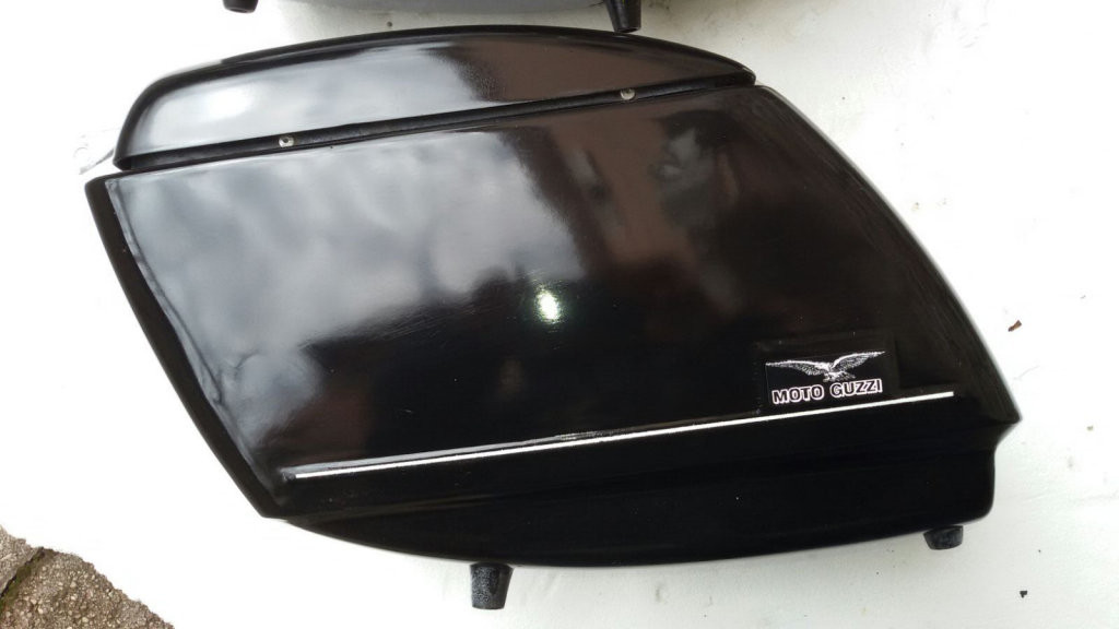 Original Moto Guzzi saddlebags that have had the handles removed from the lid (smaller).