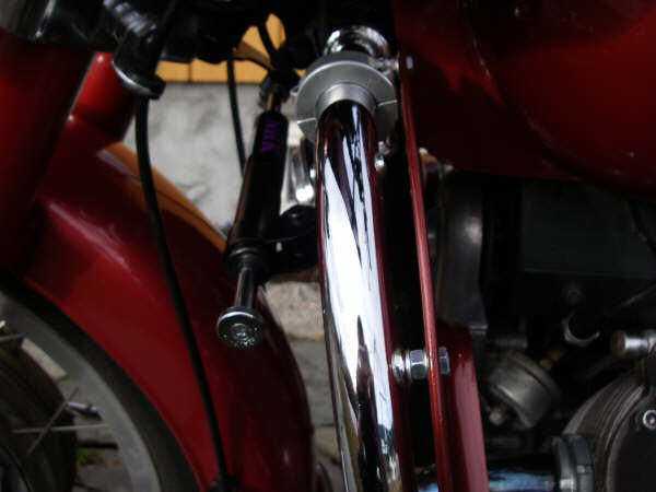 Joe Jump's steering damper kit fit to Frank Granli's motorcycle with leg shields.