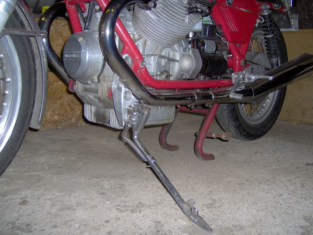 Side stand bracket enabling the fitment of a long side stand on a Moto Guzzi 850 T.