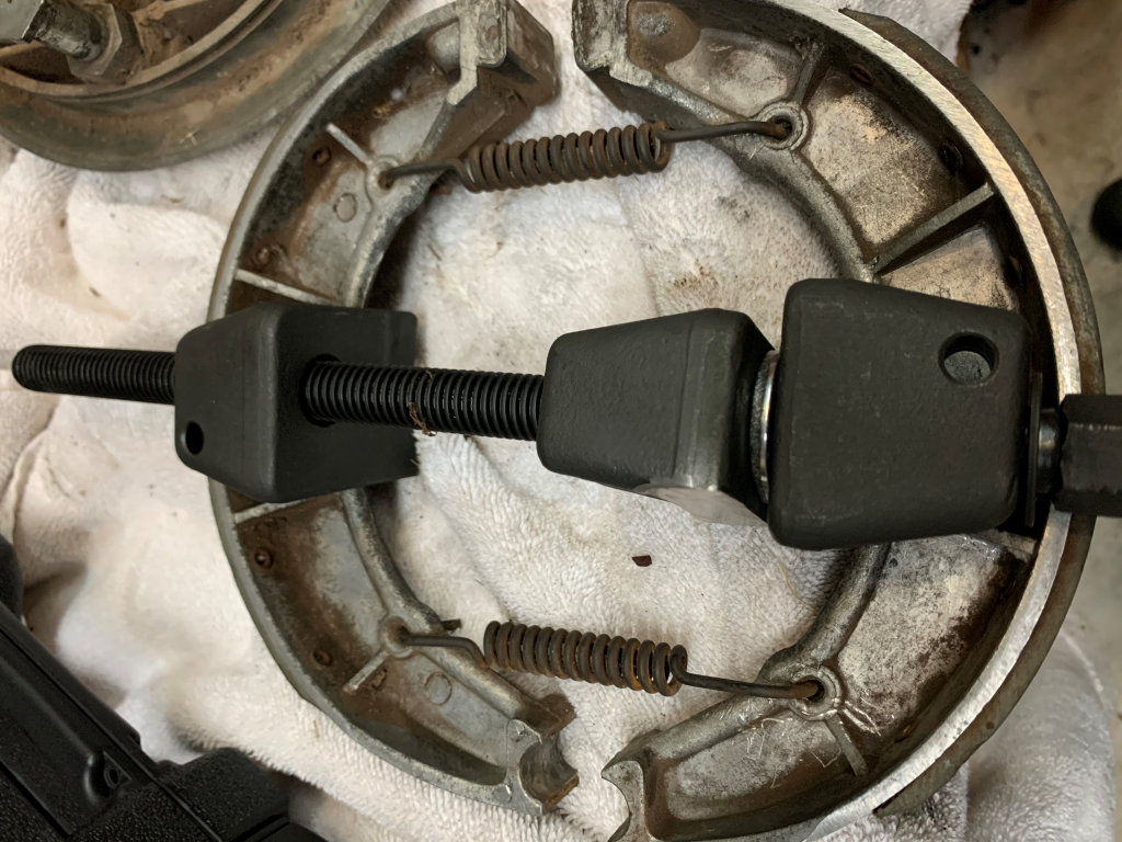 Using a MacPherson Strut Spring Compressor to spread brake shoes on Moto Guzzi V700, V7 Special, Ambassador, 850 GT, 850 GT California, Eldorado, and 850 California Police models.